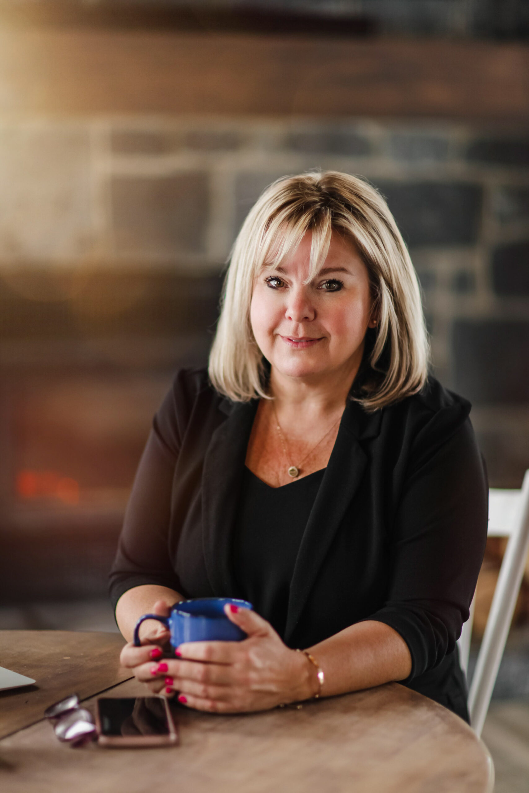 Tanya Flaro sitting at a table with a coffee